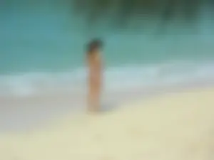 Hot Skinny Girl in Sunglasses and Swimsuit at the Beach
