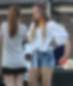 Hippie type dressed girl in denim shorts with a nice ass