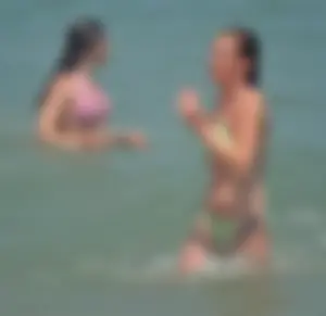 Milf at the beach in the water with hard nipples and a nice body