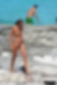Older lady on a nude beach showing her body