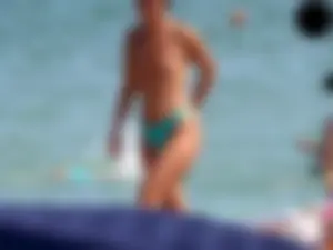 Brunette topless babe with cute tits and a nice ass in a thong bikini