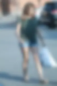 Cutie walking in the parking lot in jean shorts