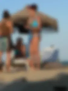 A bunch of hot babes on the beach in thong bikinis