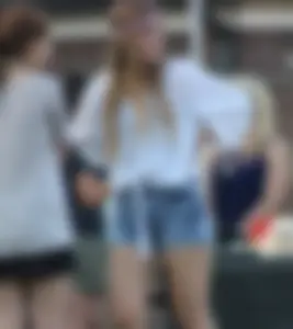 Hippie type dressed girl in denim shorts with a nice ass