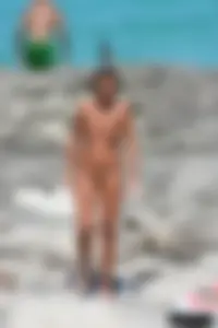 Older lady on a nude beach showing her body