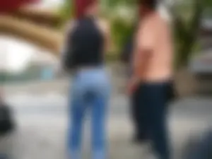Red haired lady with a nice ass in tight jeans waiting for the bus