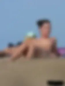 Sexy babe with a nice body topless and in a thong on the beach