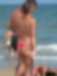 A bunch of hot babes on the beach in thong bikinis