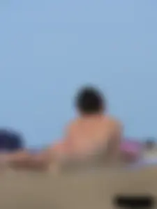 Sexy babe with a nice body topless and in a thong on the beach