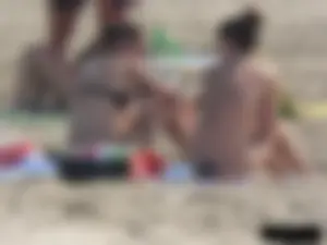 Sexy babe with a nice body topless and in a thong on the beach