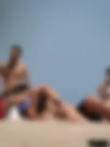 Topless lady on the beach in a gold thong with a nice ass