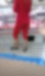 Supermarket girl in red short tights
