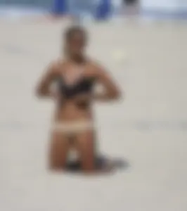 Hot girls playing beach volleyball in bikinis and shorts
