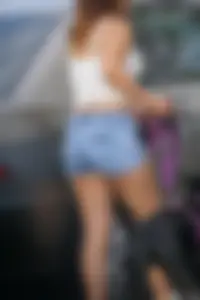 Sexy dog walker in shorts and tank top with friend in blue jeans