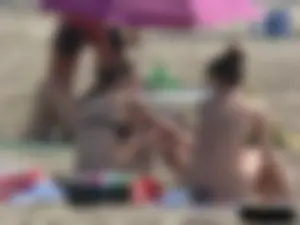 Sexy babe with a nice body topless and in a thong on the beach