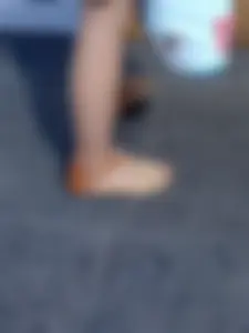 Teen feet in sandals and pantyhose on the street closeup photos
