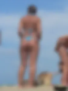 Sexy lady on the beach in a blue thong bikini