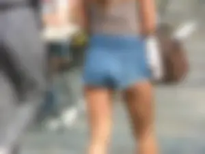 Cute girl showing her cheeks in short denim shorts