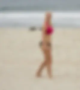 Hot girls playing beach volleyball in bikinis and shorts