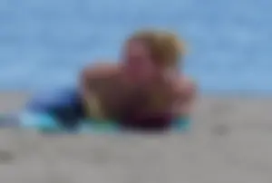 Sexy ass blonde milf on the beach in a thong with cameltoe and bending over