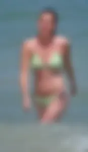 Milf at the beach in the water with hard nipples and a nice body