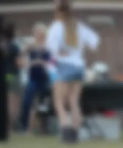 Hippie type dressed girl in denim shorts with a nice ass