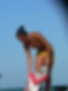 Bunch of sexy babes on the beach topless and in thong bikinis