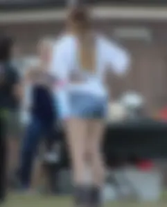 Hippie type dressed girl in denim shorts with a nice ass