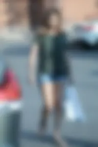 Cutie walking in the parking lot in jean shorts