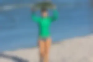 Candid girls surfing on the beach