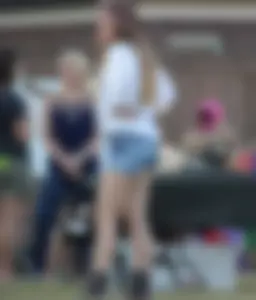 Hippie type dressed girl in denim shorts with a nice ass
