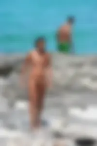 Older lady on a nude beach showing her body