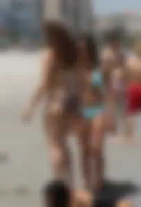 Brunette and redhead on the beach in bikinis looking sexy