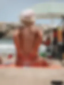 Tattooed blonde with big tits topless and in thong