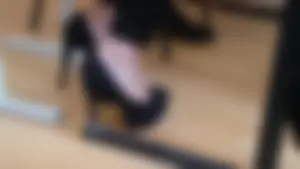 Feet in High-Heeled Shoes Closeup in College Classroom
