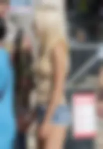 Sexy blonde in shorts and tank top with no bra and puffy nipples