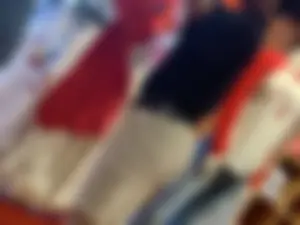 Bunch of girls in various outfits at a Cardinals baseball game