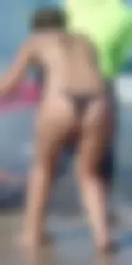 Milf on the beach in a thong bikini