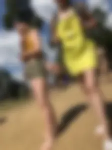 Cute Barefoot Candid Girl in Shorts and a Top Smoking at the Beach