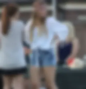 Hippie type dressed girl in denim shorts with a nice ass