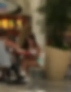 Cross-Legged Girl in Sneakers And Mini-Shorts at a Cafe in a Mall Creepshot