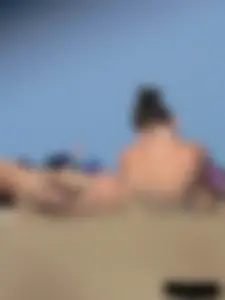 Sexy babe with a nice body topless and in a thong on the beach