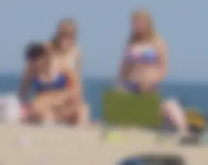 3 girls on the beach in bikinis with big boobs, one brunette and two blondes