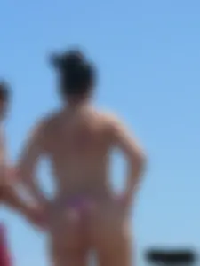 Purple thong topless lady on the beach gets oiled up by her husband