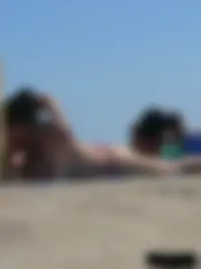 Purple thong topless lady on the beach gets oiled up by her husband