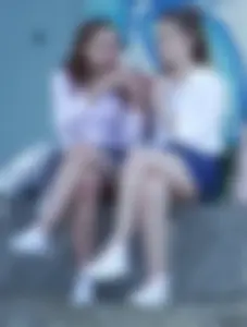 Girls in Skirts Sitting Cross-Legged Street Creepshot