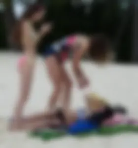 Two candid skinny teen sisters in bikinis