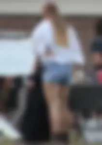 Hippie type dressed girl in denim shorts with a nice ass