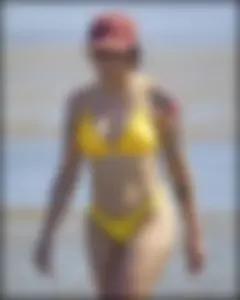 Sexy tattooed beach brunette with a great ass in yellow thong bikini