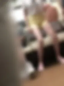 Skinny Girl in Pink Sneakers and Yellow Shorts Standing Up in a Subway Train